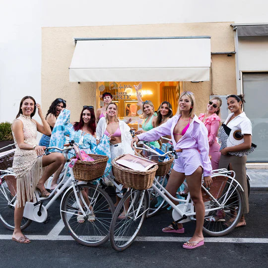 immagine che mostra tutte le ragazze che hanno partecipato con Rue des Mille all'evento di Forte dei Marmi davanti alla boutique con le biciclette